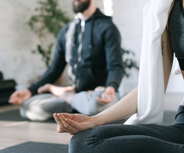 Cozy and calm corner of a room with a yoga mat, ready for practice.